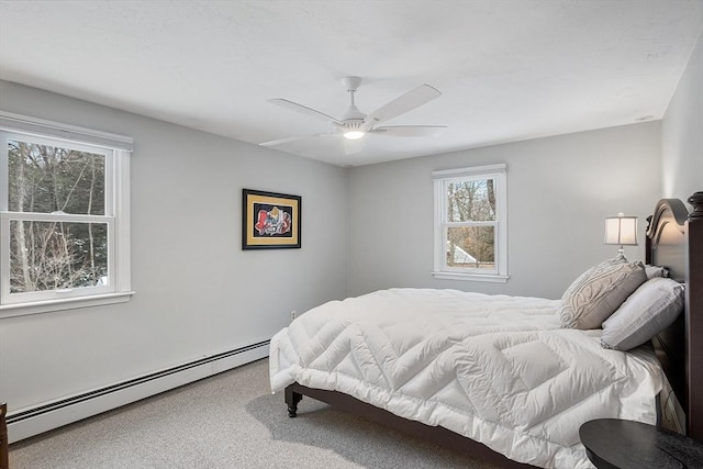 bedroom featuring ceiling fan, a baseboard radiator, and carpet flooring