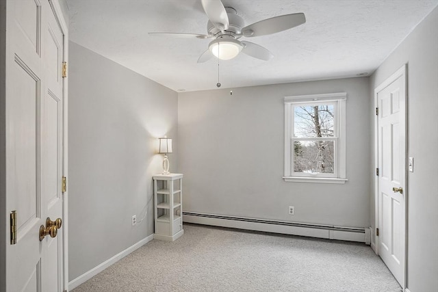 unfurnished bedroom featuring ceiling fan and a baseboard radiator