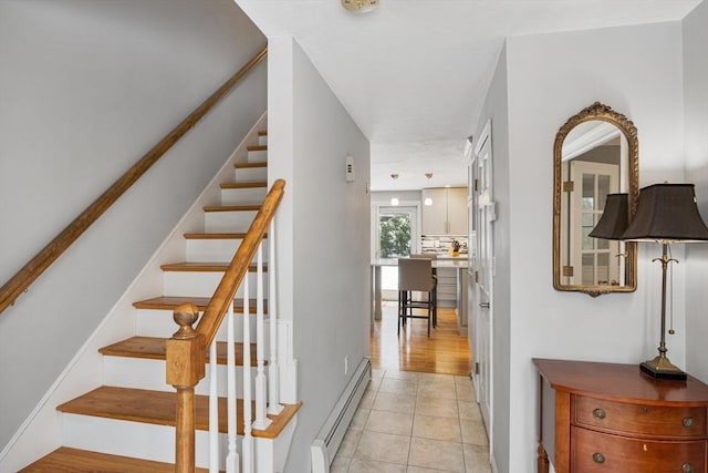 stairway with tile patterned flooring and baseboard heating