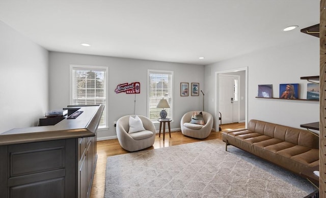 living room featuring recessed lighting, light wood finished floors, and baseboards