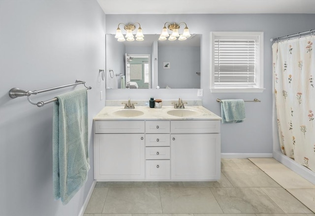 bathroom with double vanity, a sink, baseboards, and an inviting chandelier