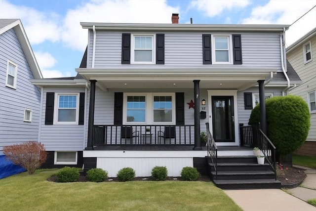 142 Vinal St, Revere, MA 02151 - view of front of property featuring a porch, a chimney, and a front yard