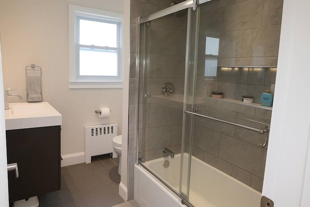 142 Vinal St, Revere, MA 02151 - bathroom featuring radiator heating unit, vanity, enclosed tub / shower combo, and tile patterned floors