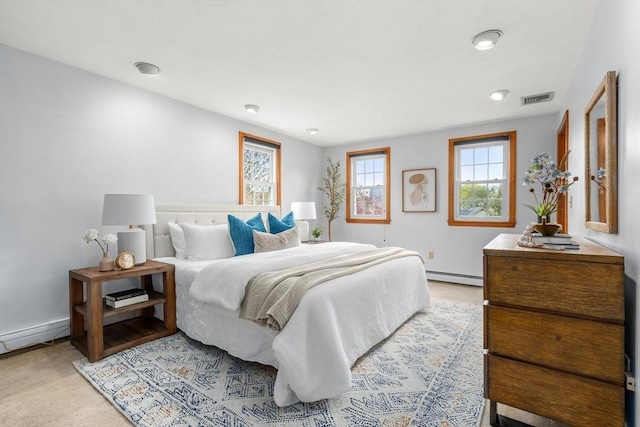 bedroom featuring carpet flooring, visible vents, baseboards, and a baseboard radiator