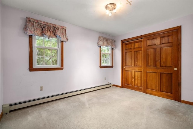 unfurnished bedroom featuring baseboards, carpet, and a baseboard radiator