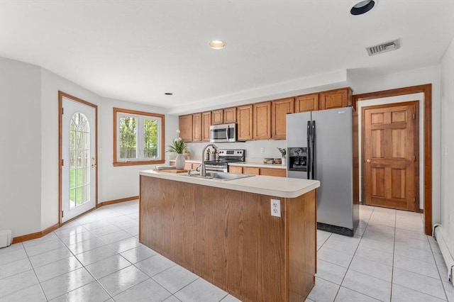 kitchen with light tile patterned flooring, visible vents, stainless steel appliances, and light countertops