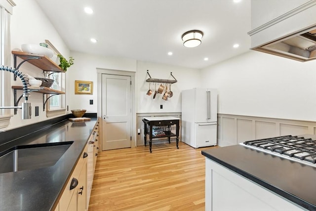 29 Hillcrest Cir Unit 2, Watertown, MA 02472 - kitchen with open shelves, freestanding refrigerator, dark countertops, stovetop, and light wood-style floors