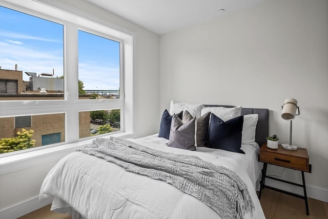 bedroom featuring baseboards and wood finished floors