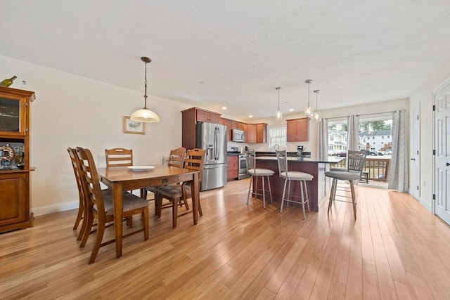 dining area featuring baseboards, recessed lighting, and light wood-style floors