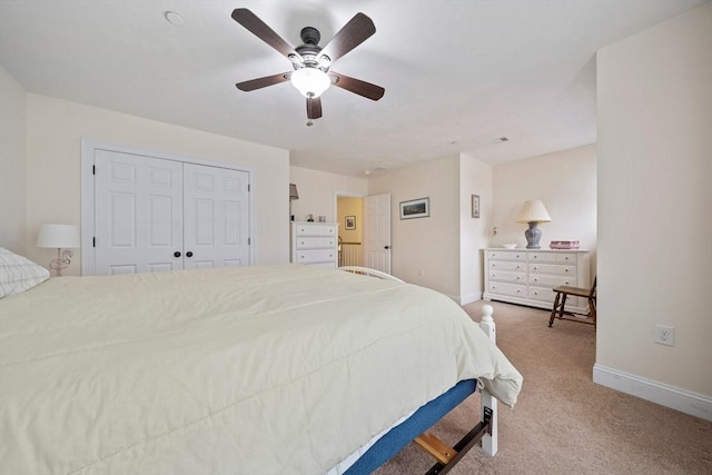 bedroom featuring baseboards, a ceiling fan, and light colored carpet