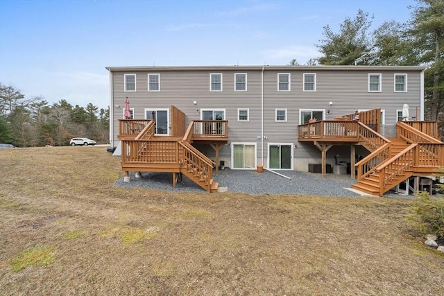 back of property with a deck, stairway, and cooling unit