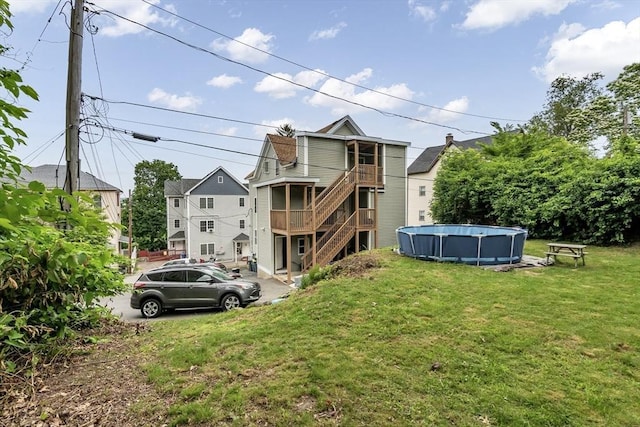 7 S Harlem St, Worcester, MA 01610 - back of house featuring stairway, an outdoor pool, and a lawn
