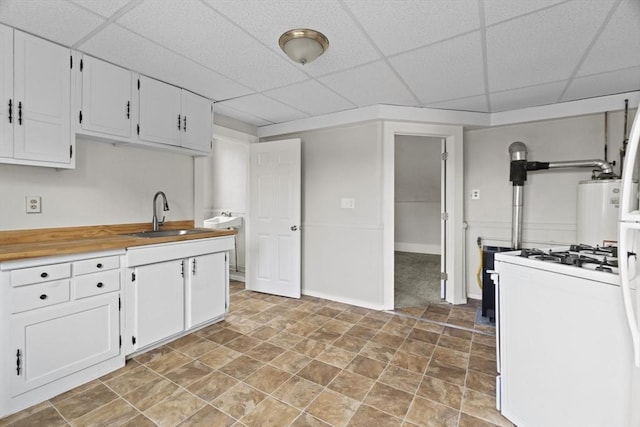 19 Park St, Webster, MA 01570 - kitchen featuring white gas stove, a sink, a paneled ceiling, white cabinets, and baseboards