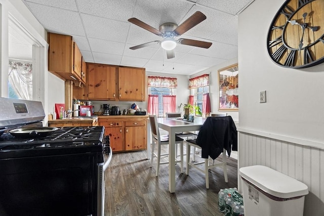 19 Park St, Webster, MA 01570 - kitchen with gas range, brown cabinets, wood finished floors, a drop ceiling, and ceiling fan