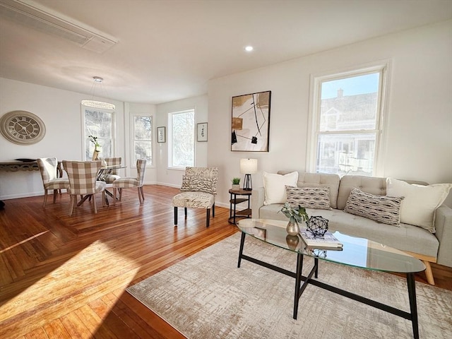 living room featuring wood-type flooring and a wealth of natural light