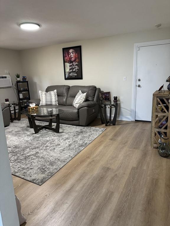 10 Walker Rd Unit 3, North Andover, MA 01845 - living area featuring wood finished floors and a wall unit AC