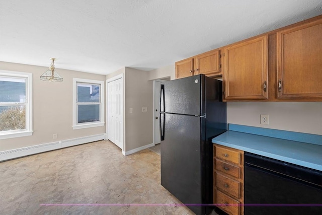 kitchen featuring hanging light fixtures, a baseboard radiator, and black appliances