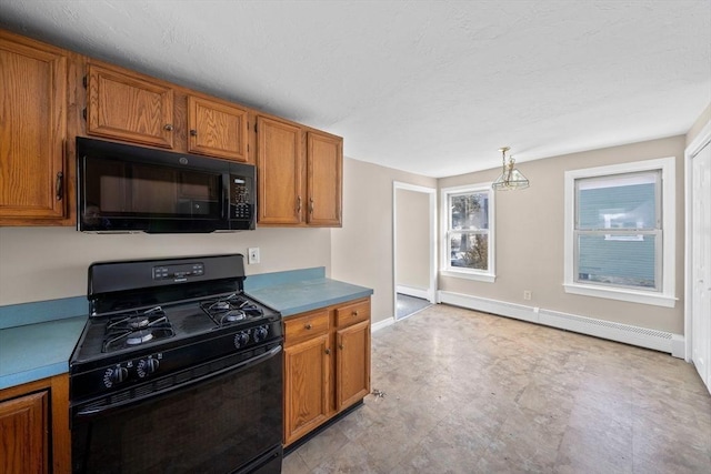 kitchen featuring pendant lighting, a baseboard radiator, and black appliances