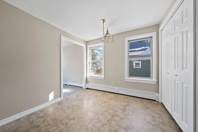 unfurnished dining area featuring baseboard heating