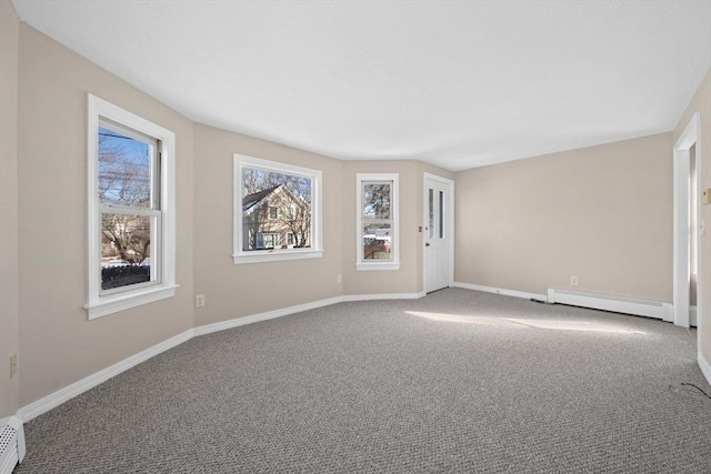 empty room with a baseboard radiator and carpet