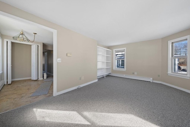 unfurnished room featuring a baseboard radiator, a healthy amount of sunlight, and carpet flooring