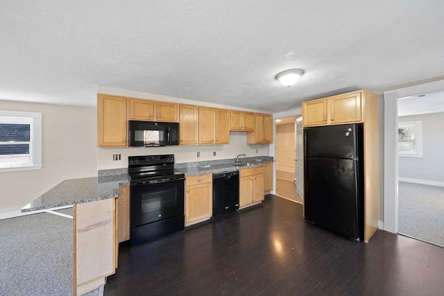 kitchen featuring dark hardwood / wood-style flooring, light brown cabinetry, sink, and black appliances