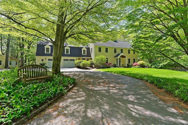 63 Claypit Hill Rd, Wayland, MA 01778 - colonial house with asphalt driveway and a front lawn