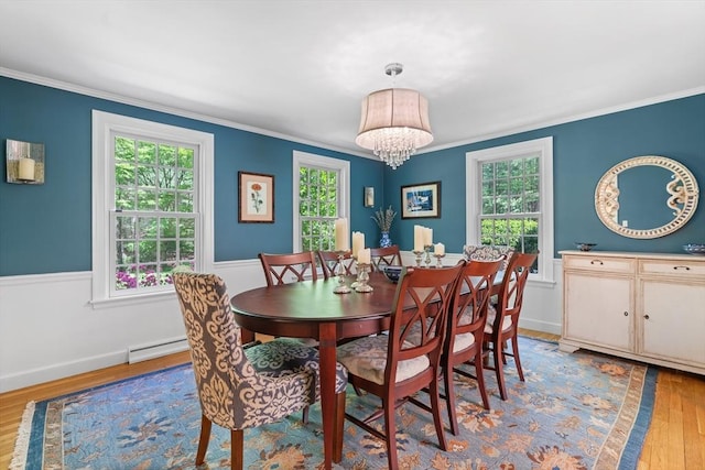 63 Claypit Hill Rd, Wayland, MA 01778 - dining area with baseboard heating, wood finished floors, a chandelier, and ornamental molding