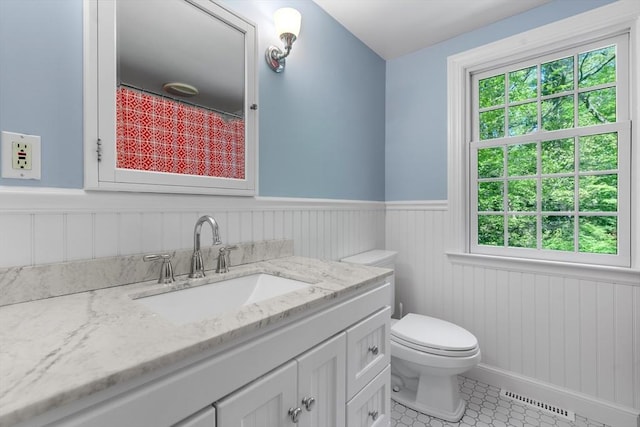 63 Claypit Hill Rd, Wayland, MA 01778 - bathroom featuring vanity, wainscoting, toilet, healthy amount of natural light, and tile patterned floors