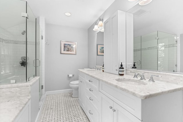 63 Claypit Hill Rd, Wayland, MA 01778 - bathroom with double vanity, a shower stall, toilet, baseboards, and tile patterned floors