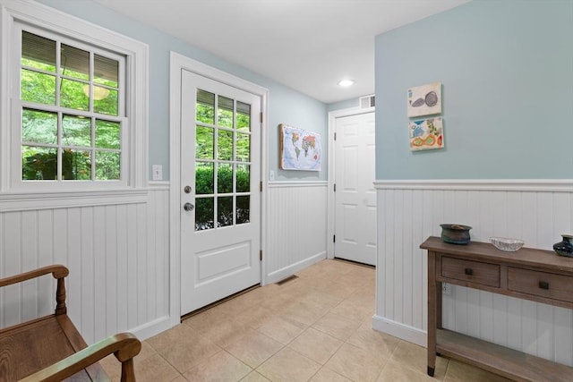 63 Claypit Hill Rd, Wayland, MA 01778 - doorway to outside featuring a wainscoted wall and light tile patterned floors