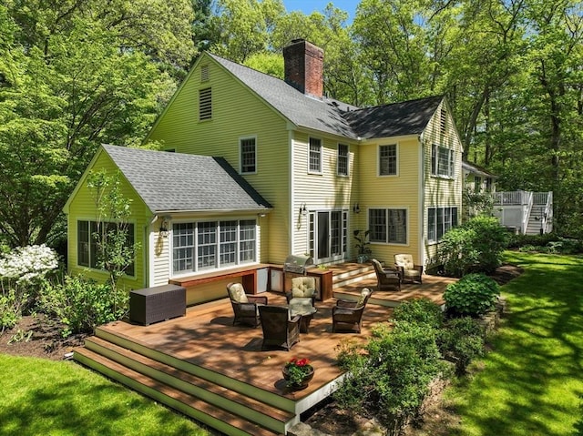63 Claypit Hill Rd, Wayland, MA 01778 - back of house with an outdoor living space, roof with shingles, a wooden deck, a chimney, and a lawn