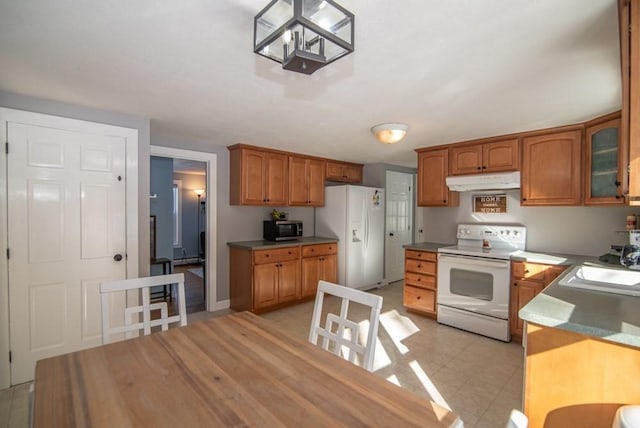 kitchen with sink and white appliances