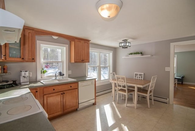 kitchen featuring baseboard heating, plenty of natural light, dishwasher, and sink