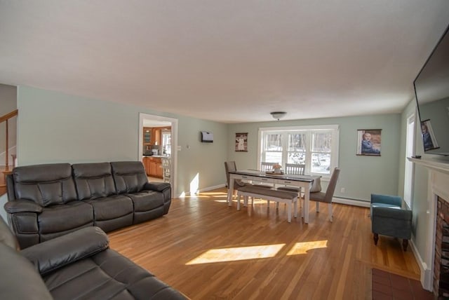 living room featuring baseboard heating and light wood-type flooring