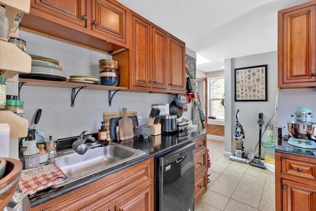 kitchen with brown cabinets, dark countertops, light tile patterned floors, and dishwasher