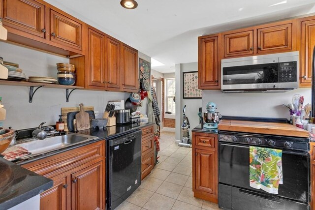 kitchen with range with gas cooktop, dishwasher, light tile patterned floors, a sink, and stainless steel microwave