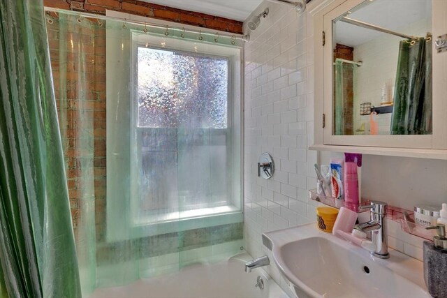 bathroom with a sink and shower / bath combo