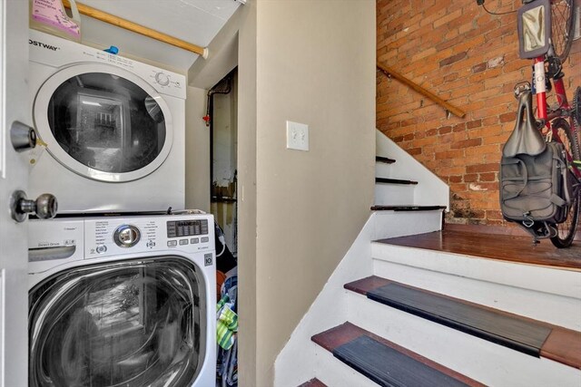 washroom featuring laundry area and stacked washer and clothes dryer