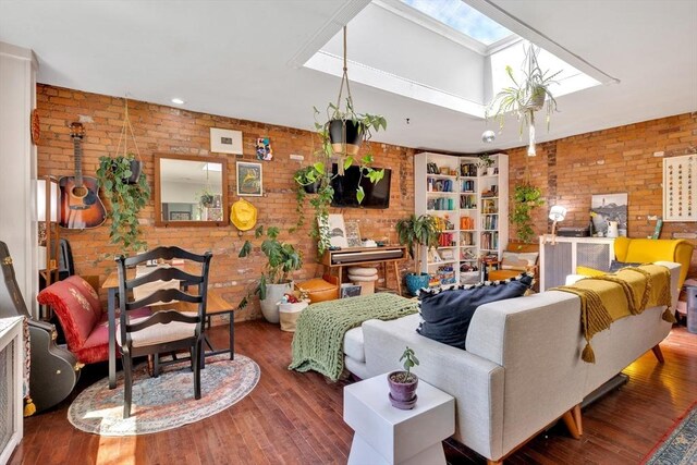 living room with wood finished floors, brick wall, and a skylight