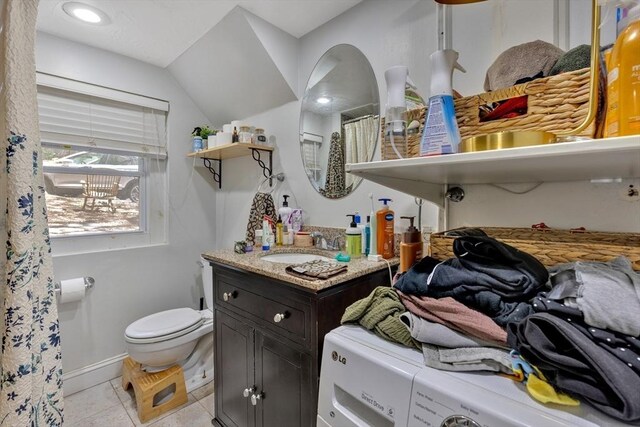 full bath with vanity, toilet, tile patterned floors, baseboards, and vaulted ceiling