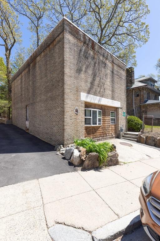 view of property exterior featuring brick siding