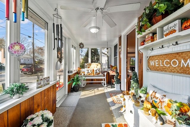 sunroom with ceiling fan