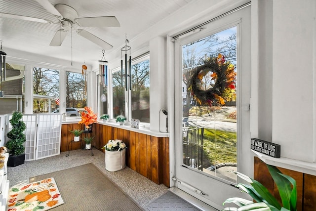 sunroom / solarium with plenty of natural light and ceiling fan