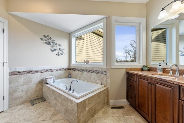 bathroom with vanity, tile patterned flooring, a bath, and visible vents