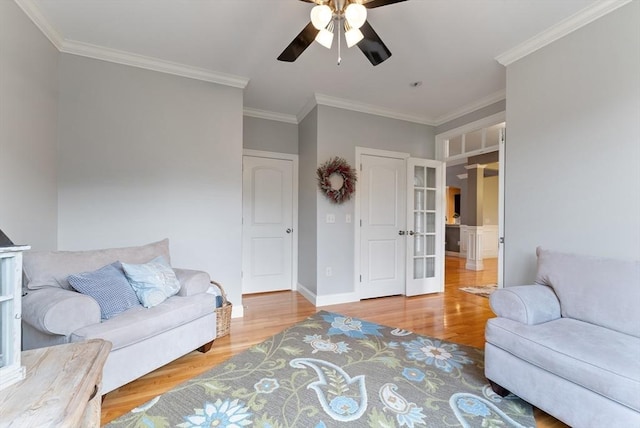 living room with french doors, a ceiling fan, wood finished floors, and ornamental molding