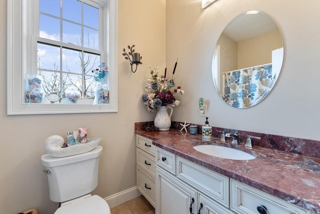 bathroom with toilet, baseboards, tile patterned floors, and vanity