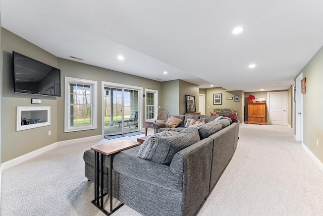 living room with baseboards, light carpet, recessed lighting, and visible vents