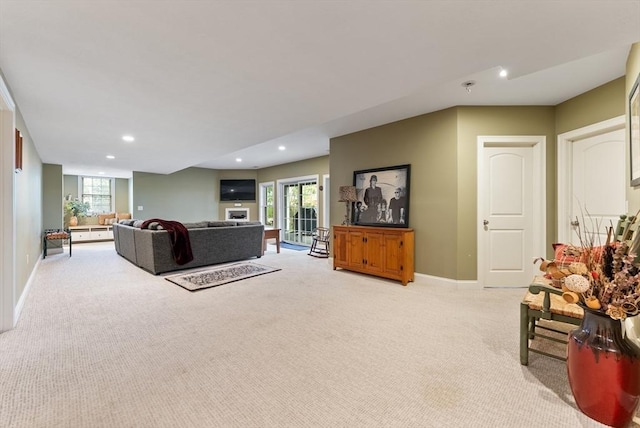 living area featuring light colored carpet, recessed lighting, baseboards, and a wealth of natural light