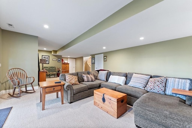 living room featuring baseboards, visible vents, recessed lighting, and light colored carpet